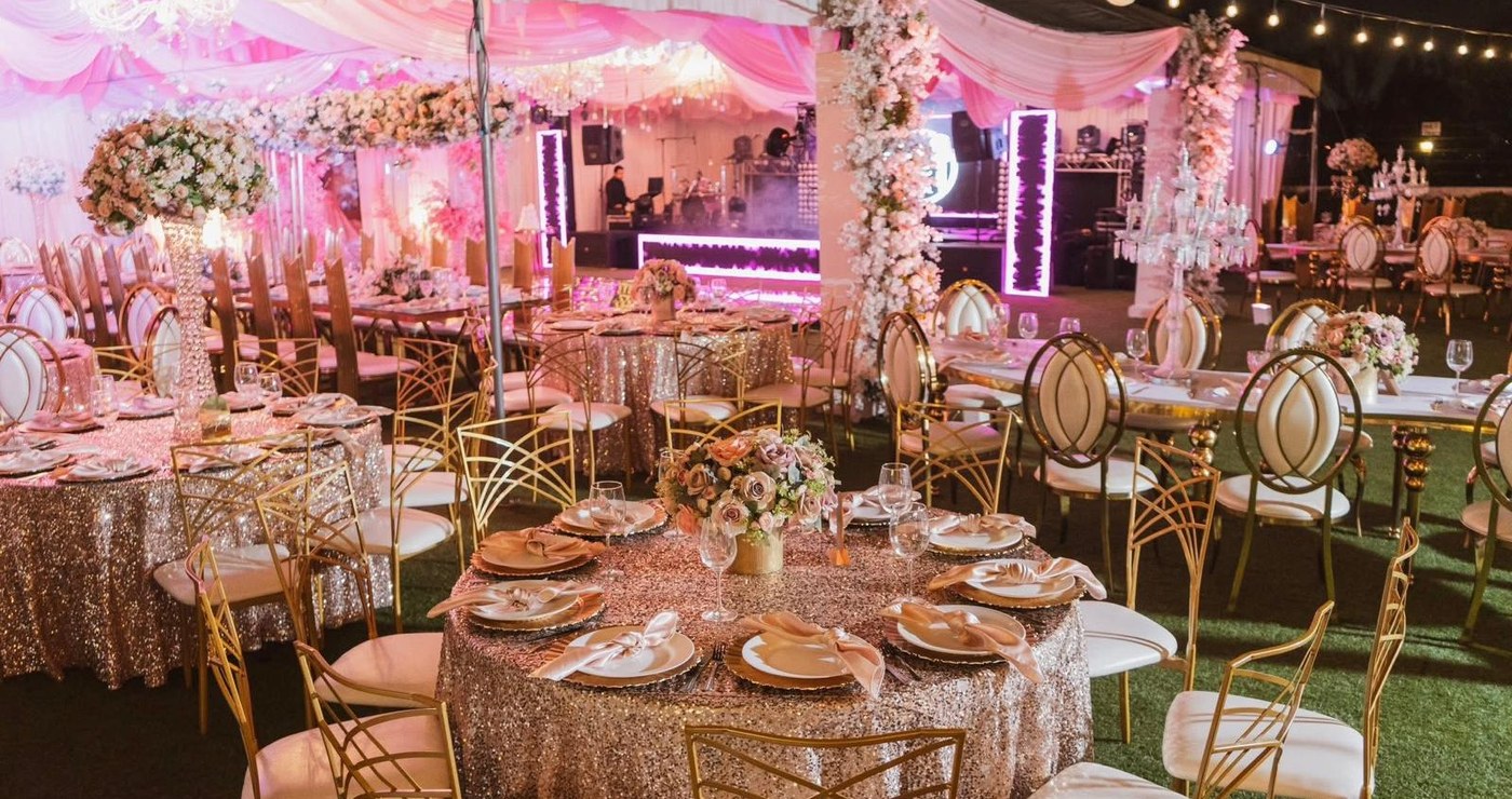 Decorated reception tent with pink uplighting