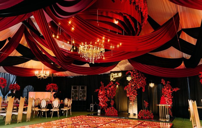 Reception hall with red uplighting and LED dance floor